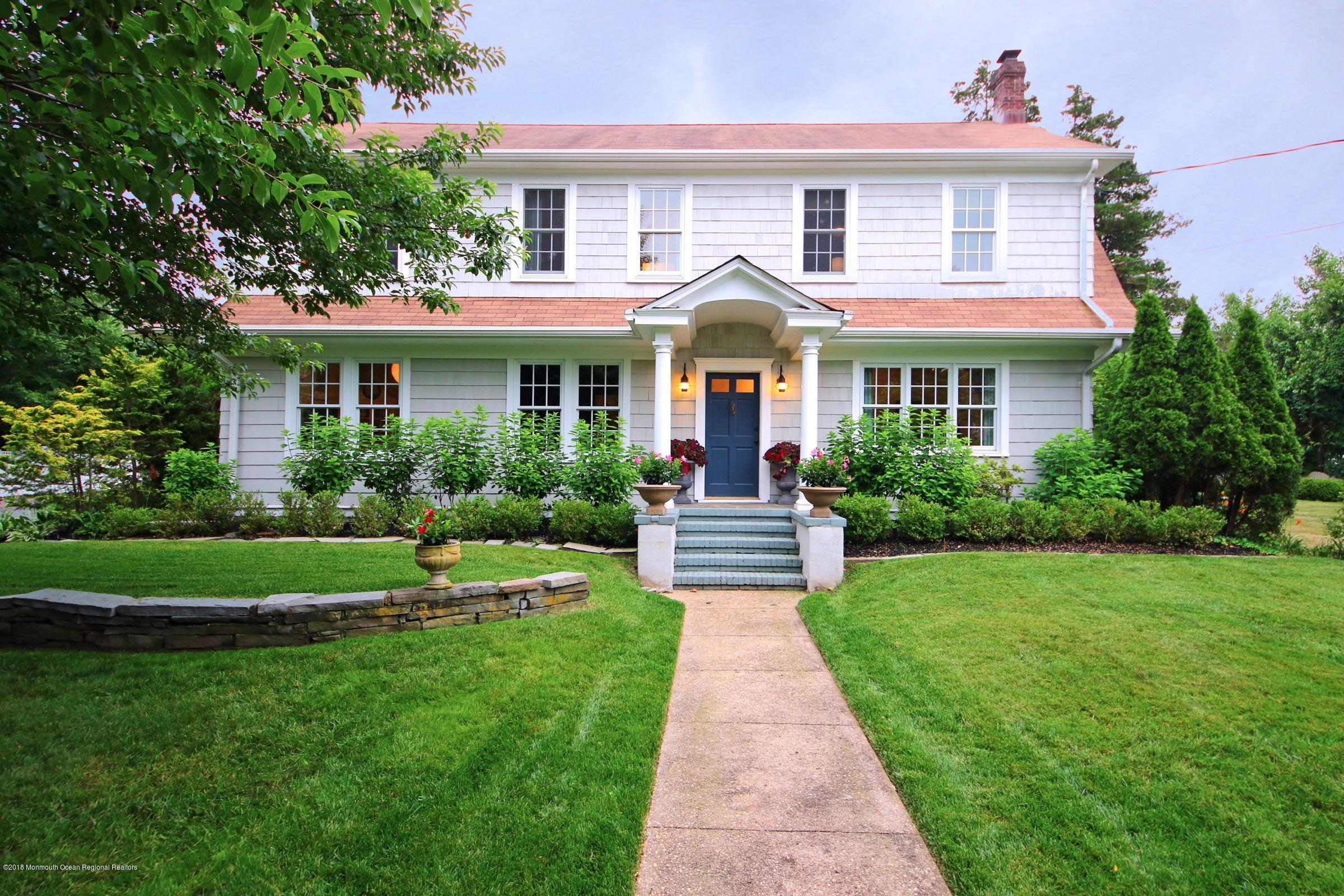 668 River Road Fair Haven, NJ 07704 - Photo 1 of 68 a front view of a house with a yard and potted plants
