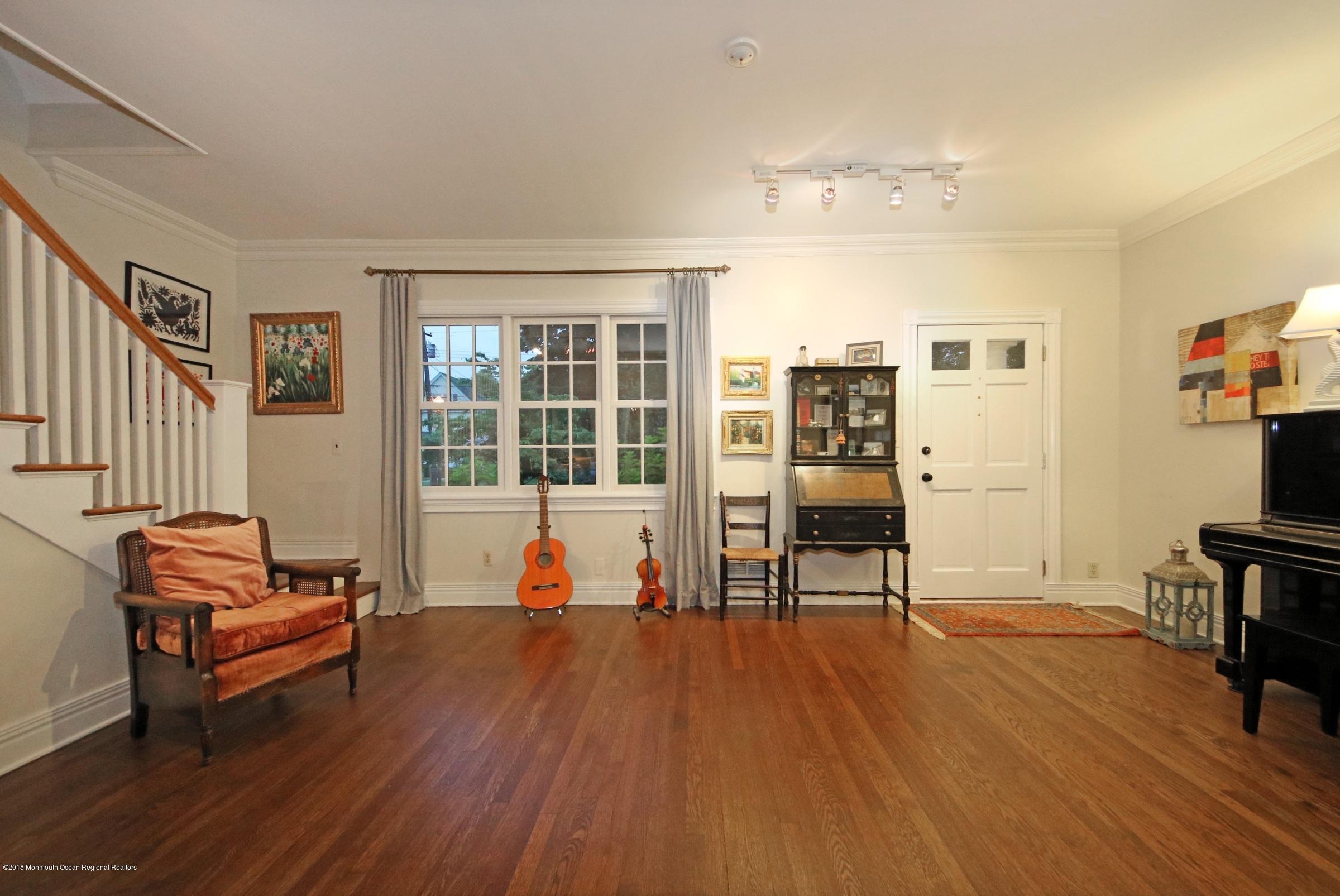668 River Road Fair Haven, NJ 07704 - Photo 18 of 68 a living room with furniture and a flat screen tv with wooden floor