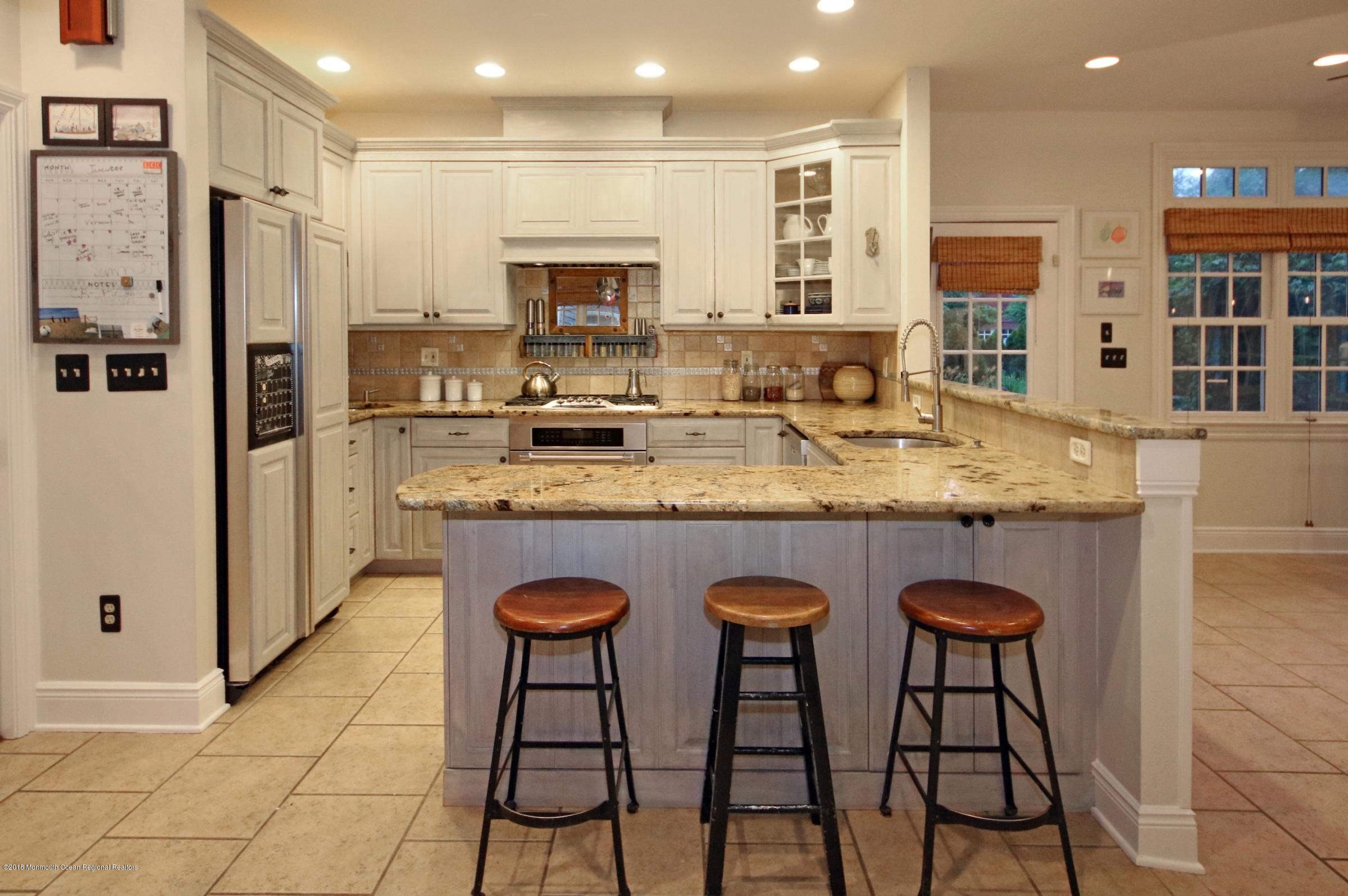 668 River Road Fair Haven, NJ 07704 - Photo 24 of 68 a kitchen with stainless steel appliances granite countertop a sink and a refrigerator