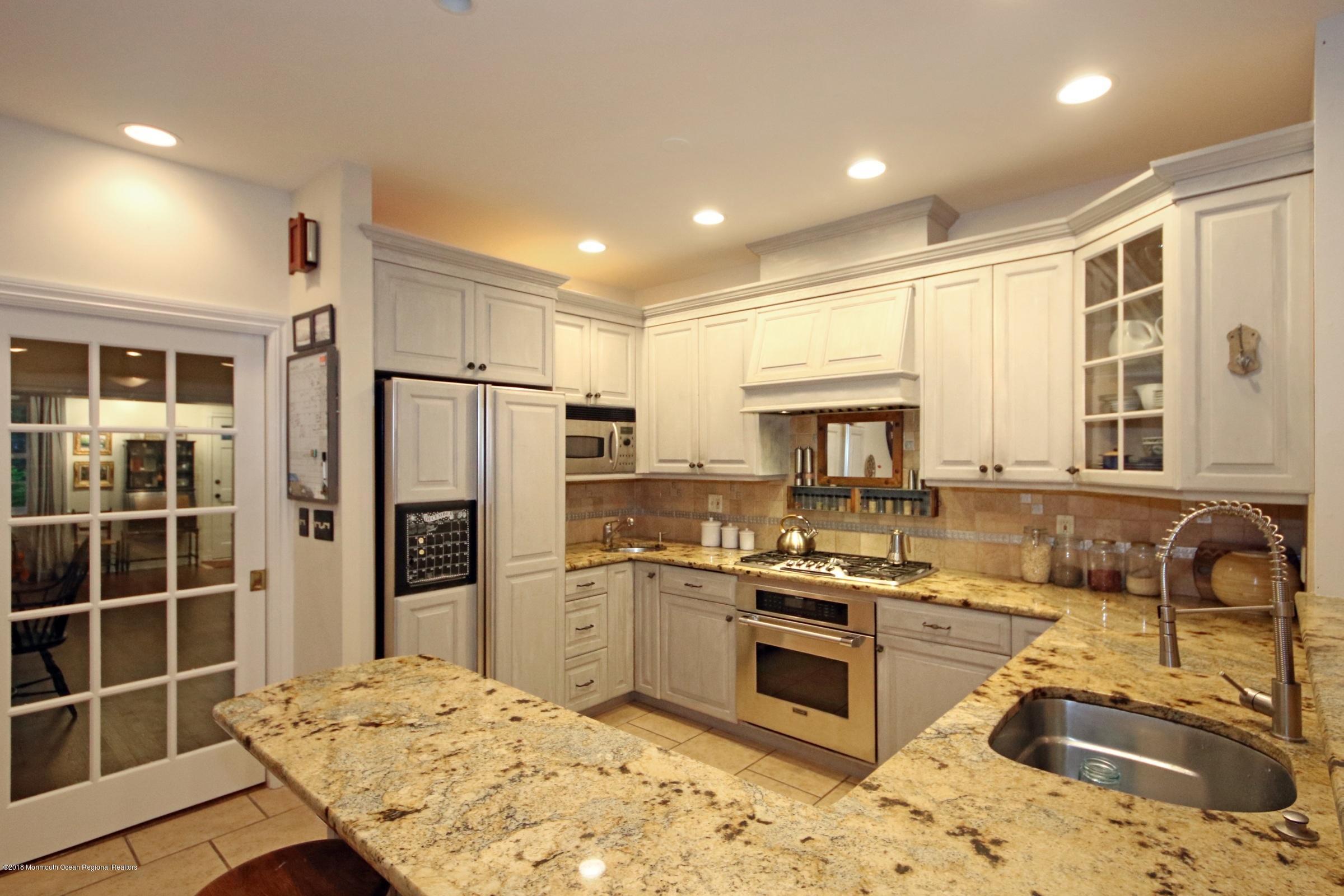668 River Road Fair Haven, NJ 07704 - Photo 26 of 68 a kitchen with stainless steel appliances granite countertop a sink stove and refrigerator