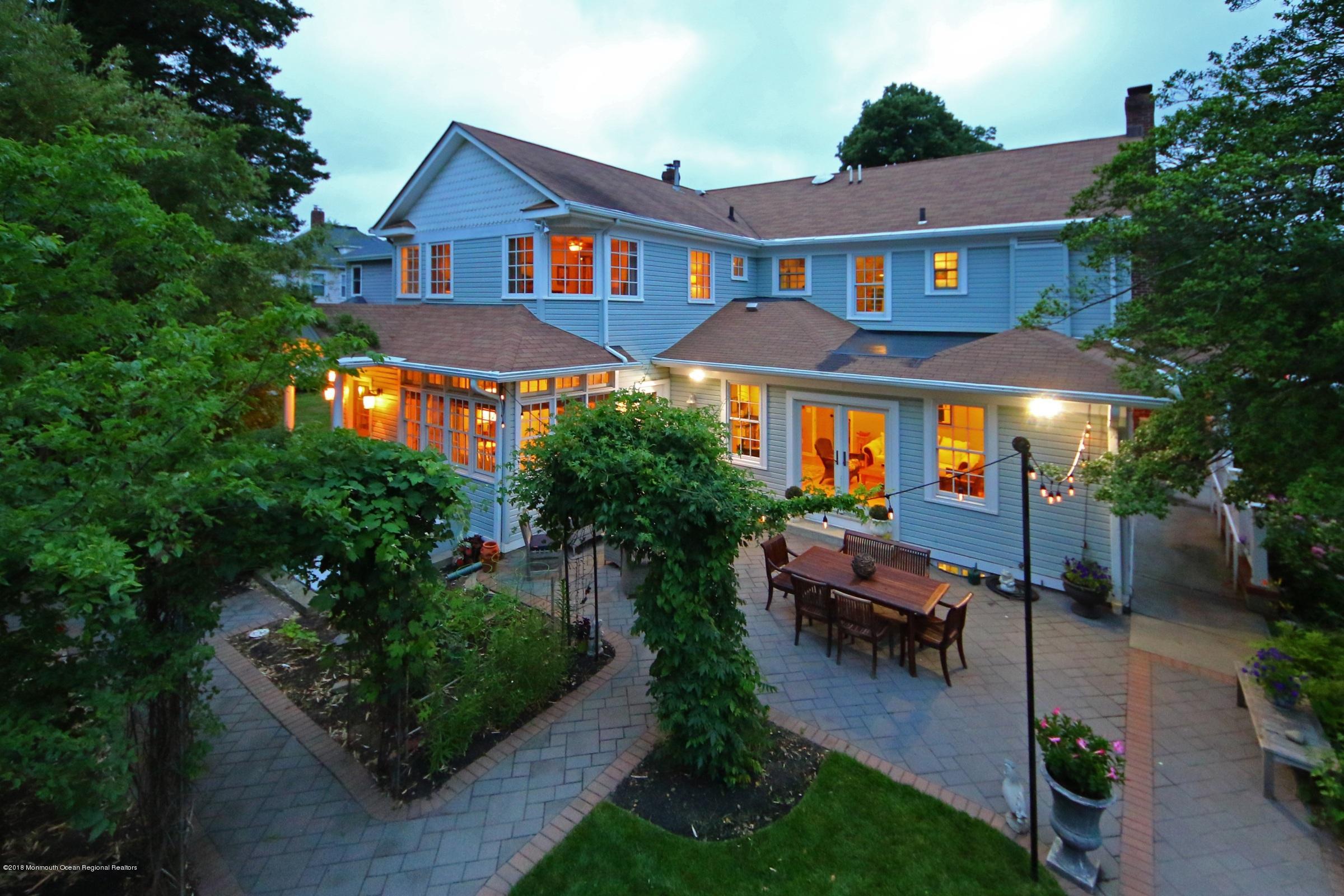 668 River Road Fair Haven, NJ 07704 - Photo 3 of 68 a front view of a house with garden and sitting area