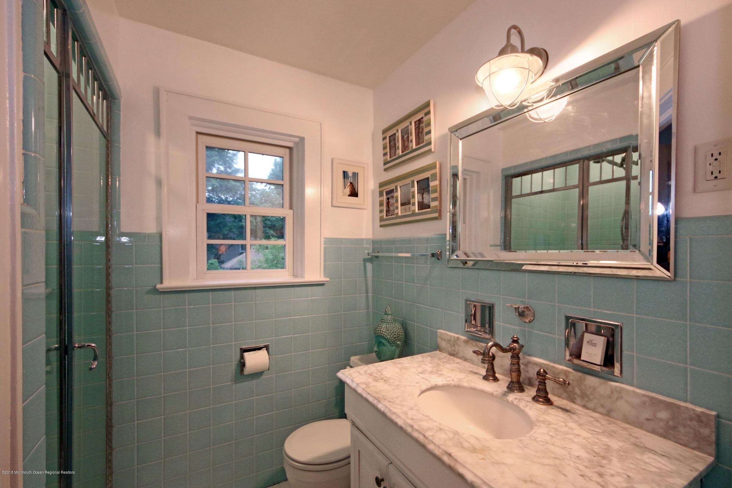 668 River Road Fair Haven, NJ 07704 - Photo 47 of 68 a bathroom with a granite countertop sink vanity mirror and toilet