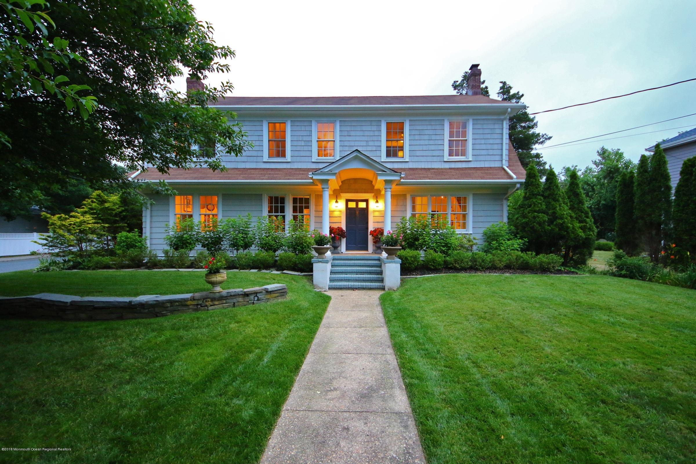 668 River Road Fair Haven, NJ 07704 - Photo 56 of 68 a front view of a house with a yard and potted plants