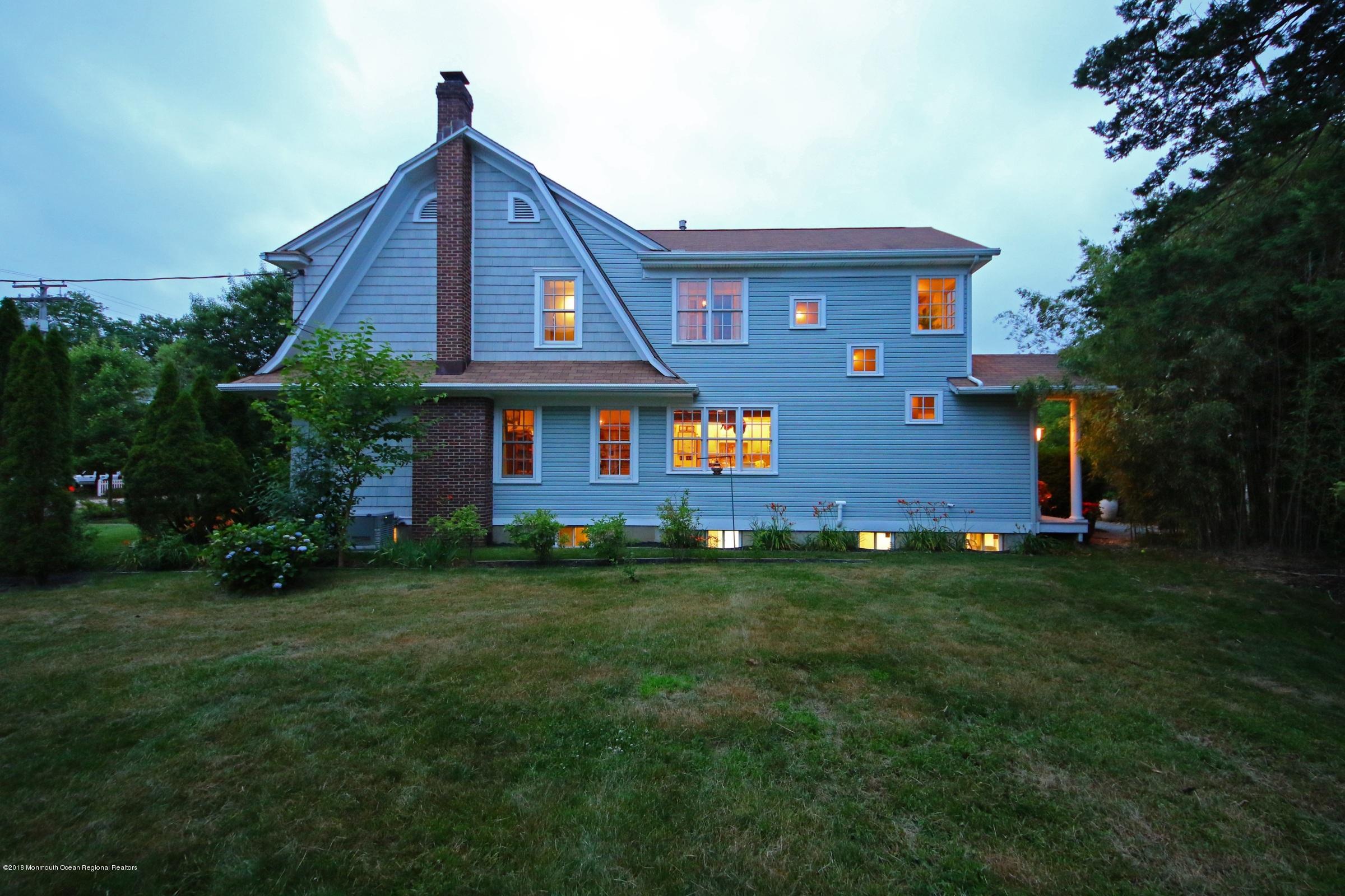 668 River Road Fair Haven, NJ 07704 - Photo 58 of 68 a front view of a house with a garden
