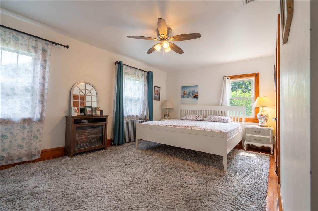 665 Point Phillips Road Bath, PA 18014 - Photo 31 of 73 A well-lit bedroom features plush carpeting, elegant windows, and a warm, inviting ambiance.