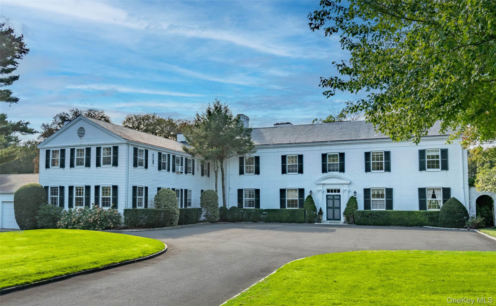 10 Lands End Road Locust Valley, NY 11560 - Photo 11 of 23 a front view of a house with a garden