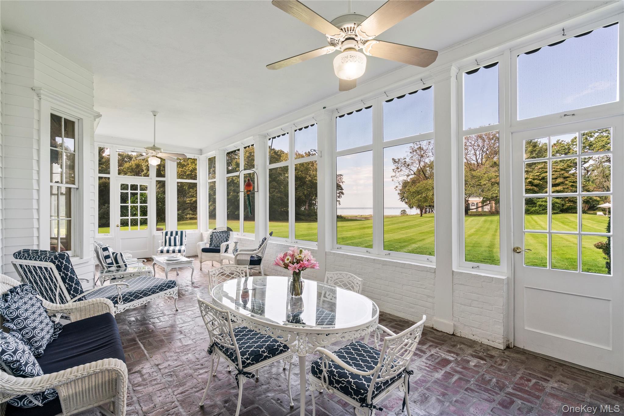10 Lands End Road Locust Valley, NY 11560 - Photo 15 of 22 a dining room with furniture a chandelier and large window