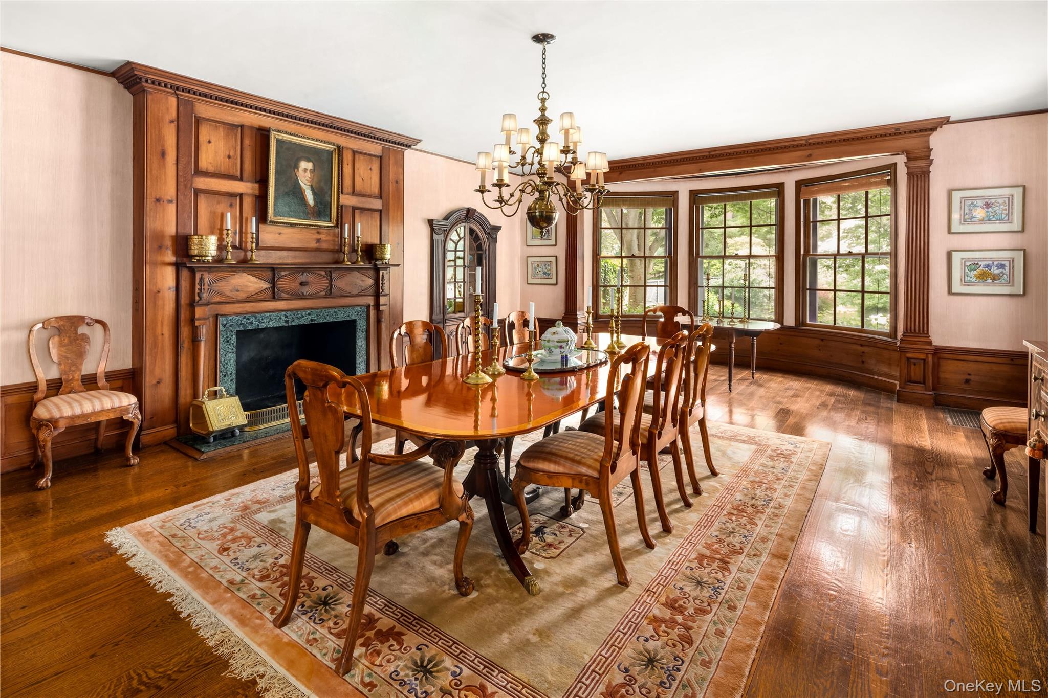 10 Lands End Road Locust Valley, NY 11560 - Photo 17 of 23 a dining room with furniture a fireplace and wooden floor