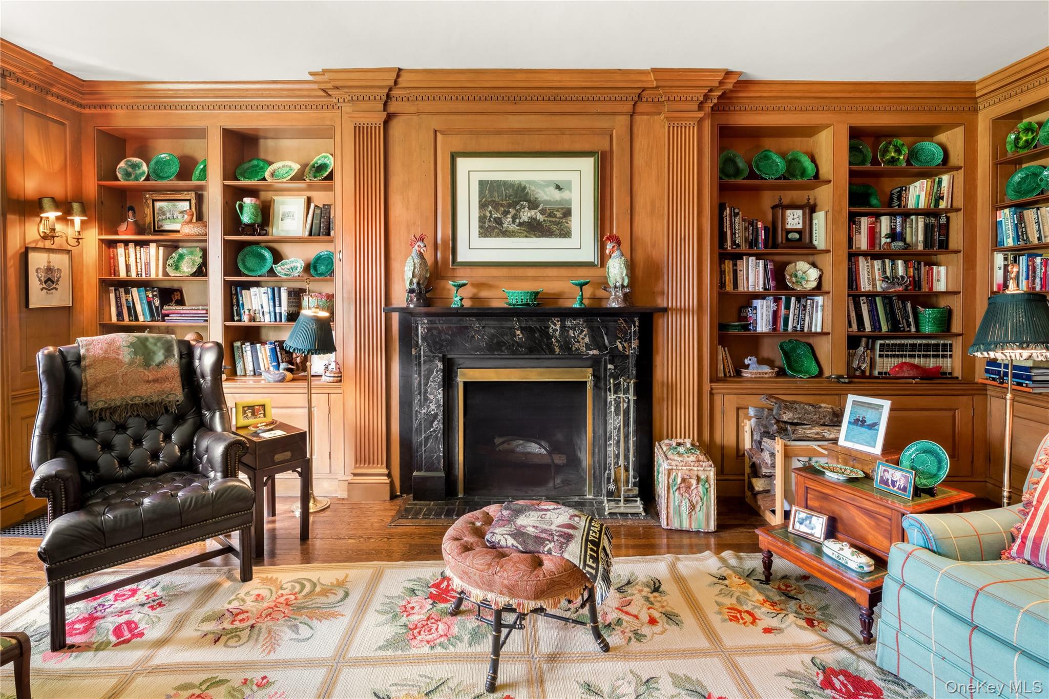 10 Lands End Road Locust Valley, NY 11560 - Photo 18 of 22 a living room with furniture a bookshelf and a fireplace