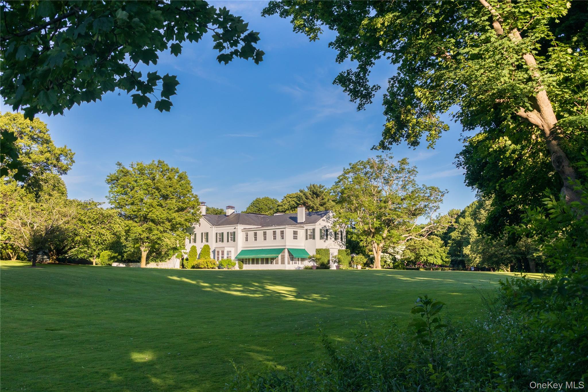 10 Lands End Road Locust Valley, NY 11560 - Photo 22 of 22 a view of a big yard with plants and large trees
