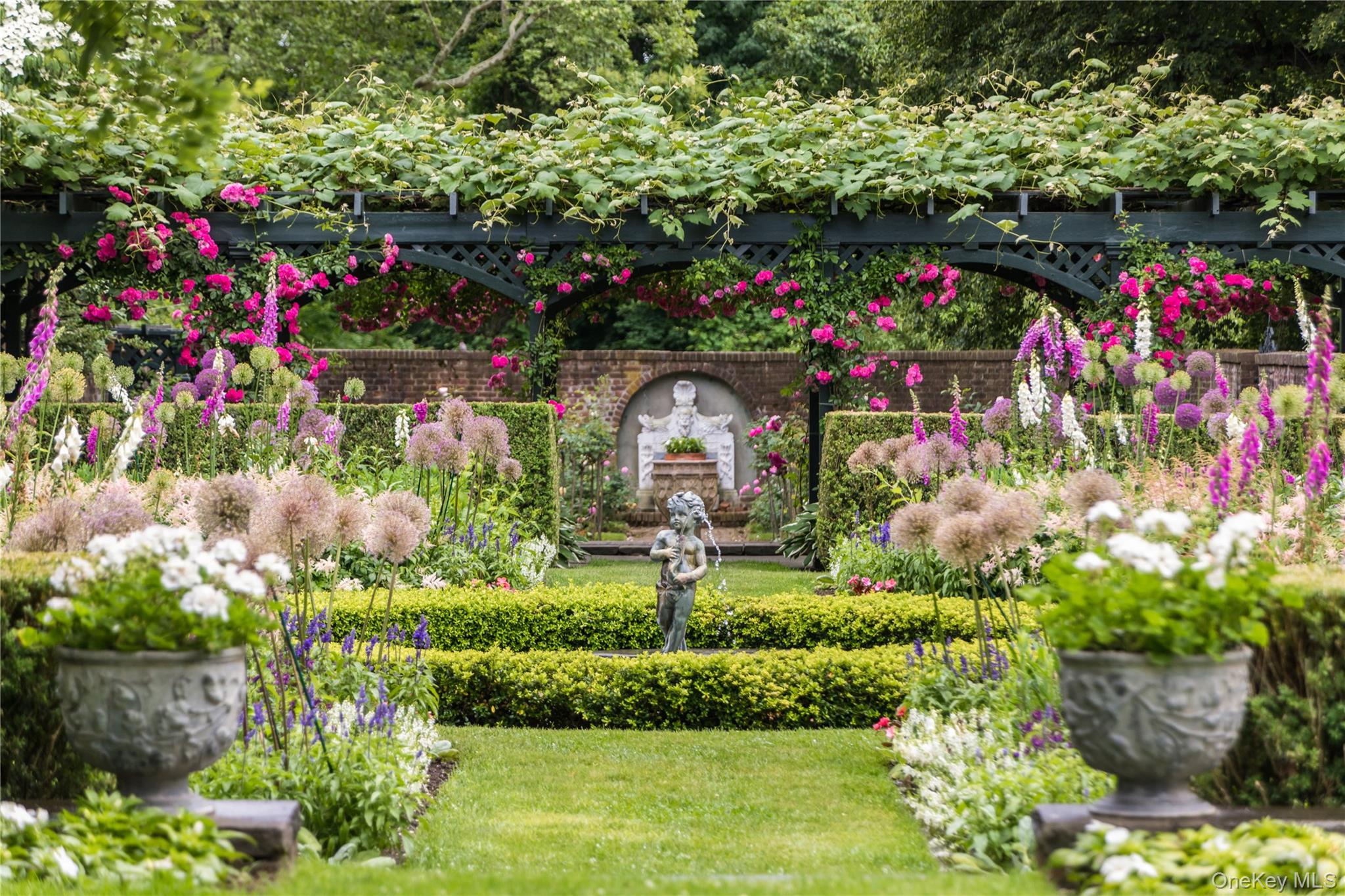 10 Lands End Road Locust Valley, NY 11560 - Photo 4 of 23 a small garden covered with lots of flowers and flowers