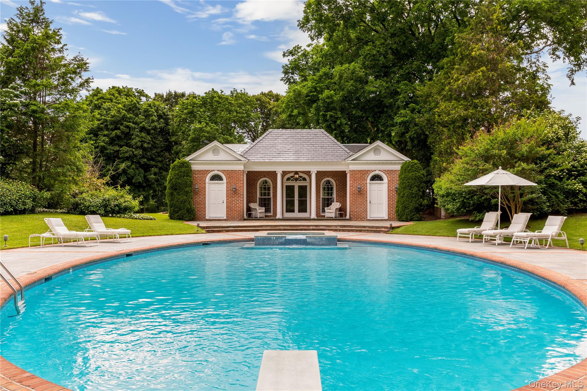 10 Lands End Road Locust Valley, NY 11560 - Photo 8 of 23 a house that has swimming pool in front of it