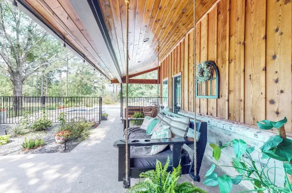 a view of a garden with plants and outdoor seating