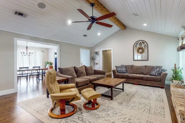 a living room with furniture and wooden floor