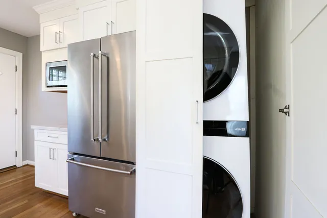 a view of kitchen with stainless steel appliances and refrigerator