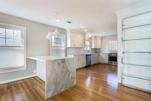 a kitchen with stainless steel appliances granite countertop a refrigerator sink and cabinets