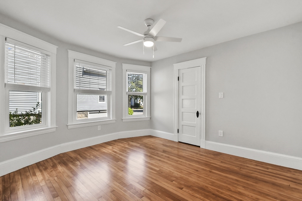 10 Cain Avenue, Unit 10 Weymouth, MA 02189 - Photo 11 of 34 a view of an empty room with wooden floor and a window