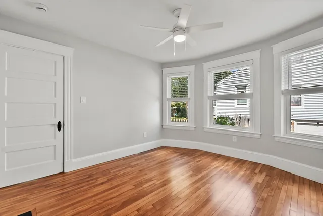 wooden floor in an empty room with a window