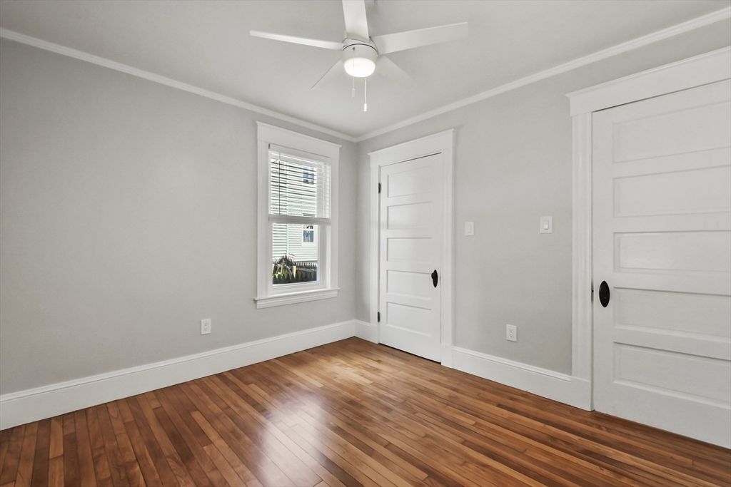 10 Cain Avenue, Unit 10 Weymouth, MA 02189 - Photo 14 of 34 an empty room with wooden floor cabinet and windows
