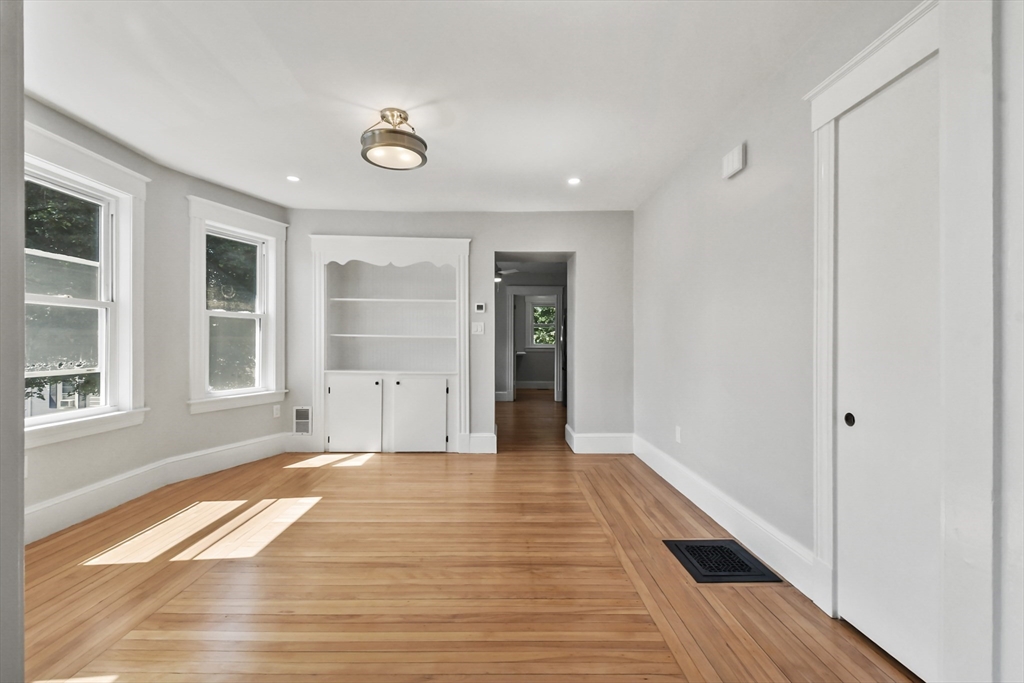 10 Cain Avenue, Unit 10 Weymouth, MA 02189 - Photo 19 of 34 a view of an empty room with wooden floor and a window