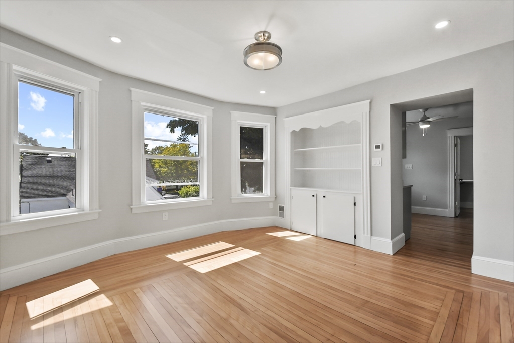 10 Cain Avenue, Unit 10 Weymouth, MA 02189 - Photo 20 of 34 a view of an empty room with wooden floor and a window