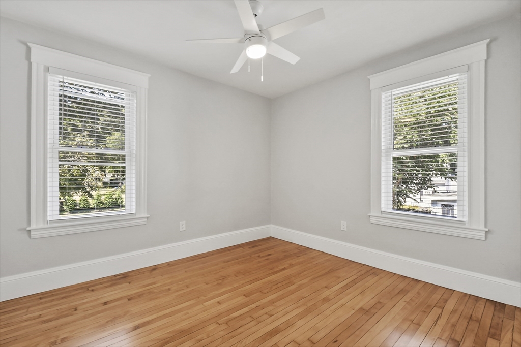 10 Cain Avenue, Unit 10 Weymouth, MA 02189 - Photo 26 of 34 an empty room with wooden floor and windows