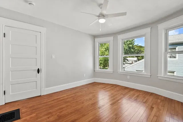 wooden floor in an empty room with a window