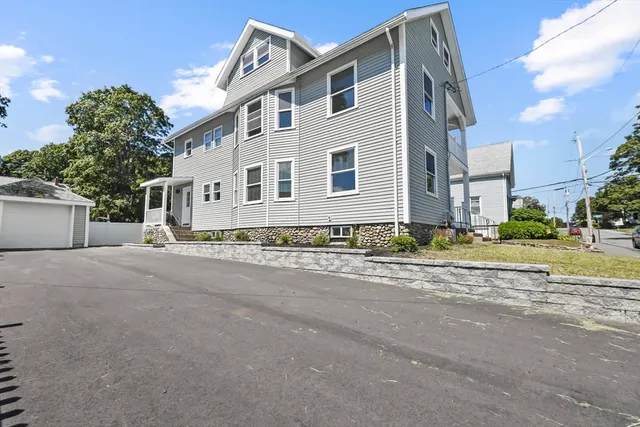 a front view of a house with a yard and a garage