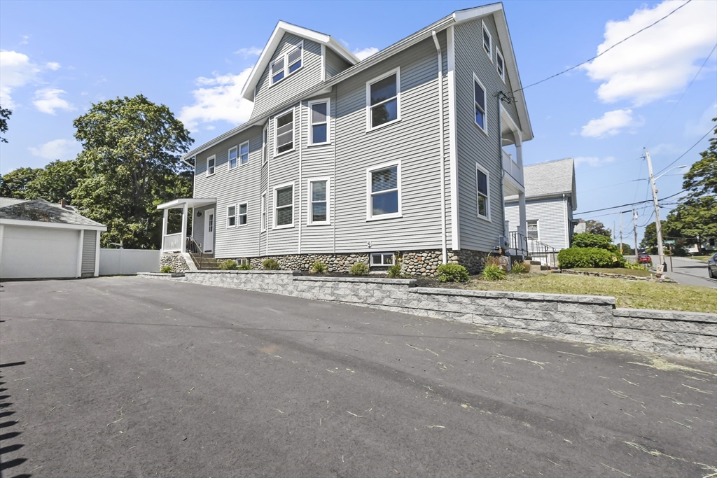 10 Cain Avenue, Unit 10 Weymouth, MA 02189 - Photo 34 of 34 a front view of a house with a yard and a garage