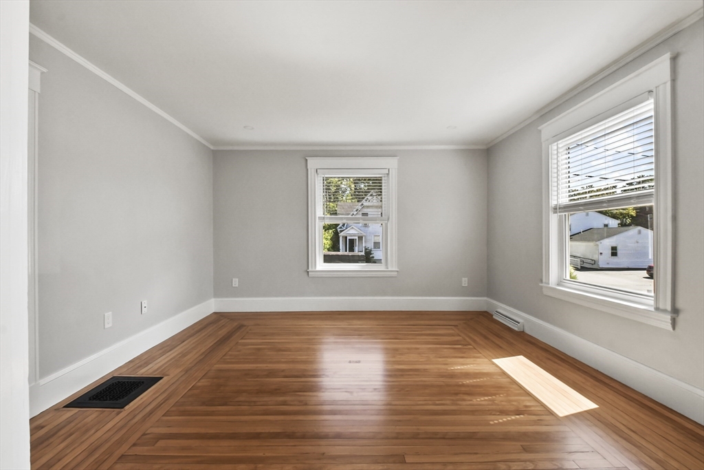 10 Cain Avenue, Unit 10 Weymouth, MA 02189 - Photo 4 of 34 a view of an empty room with wooden floor and a window