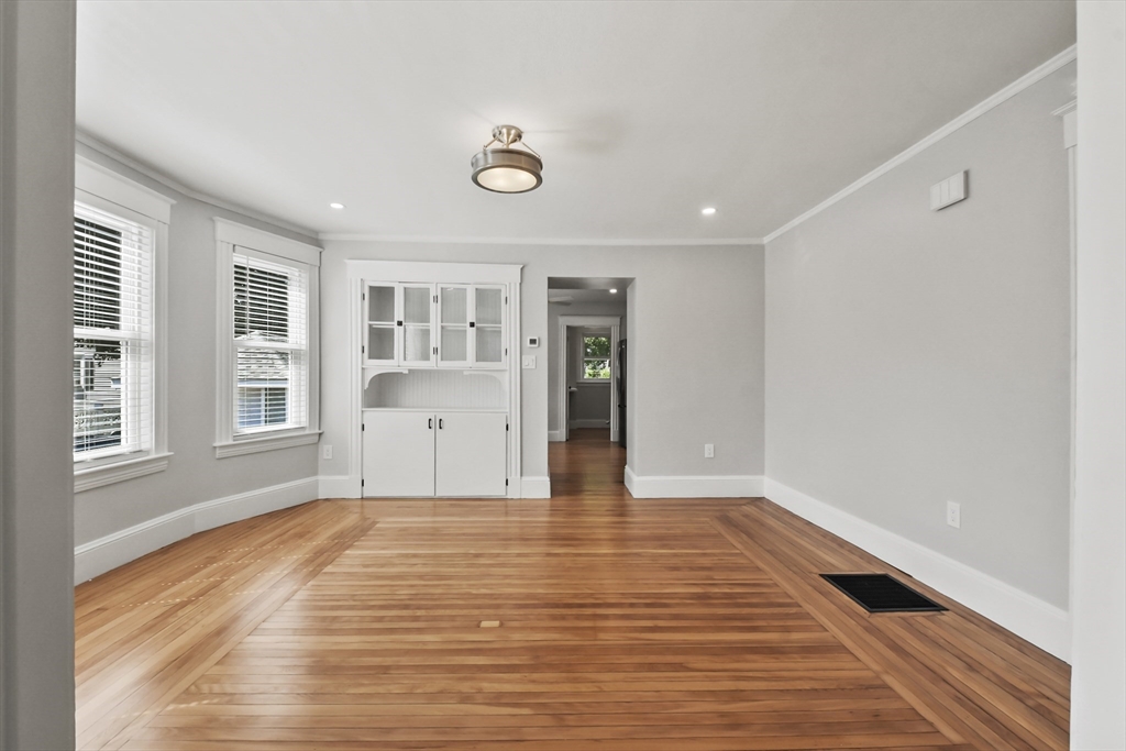 10 Cain Avenue, Unit 10 Weymouth, MA 02189 - Photo 5 of 34 a view of an empty room with wooden floor and a window