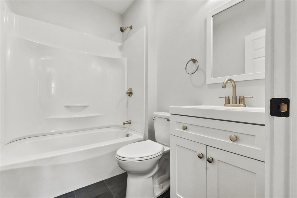 10 Cain Avenue, Unit 10 Weymouth, MA 02189 - Photo 10 of 34 a bathroom with a sink a toilet and shower