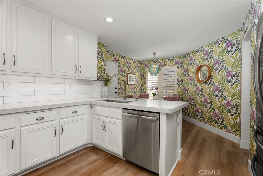 90 Cameray Heights Laguna Niguel, CA 92677 - Photo 11 of 36 a kitchen with stainless steel appliances granite countertop a sink and wooden cabinets