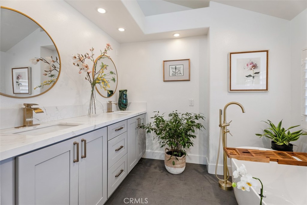 90 Cameray Heights Laguna Niguel, CA 92677 - Photo 16 of 36 a bathroom with a granite countertop sink a potted plant and a mirror