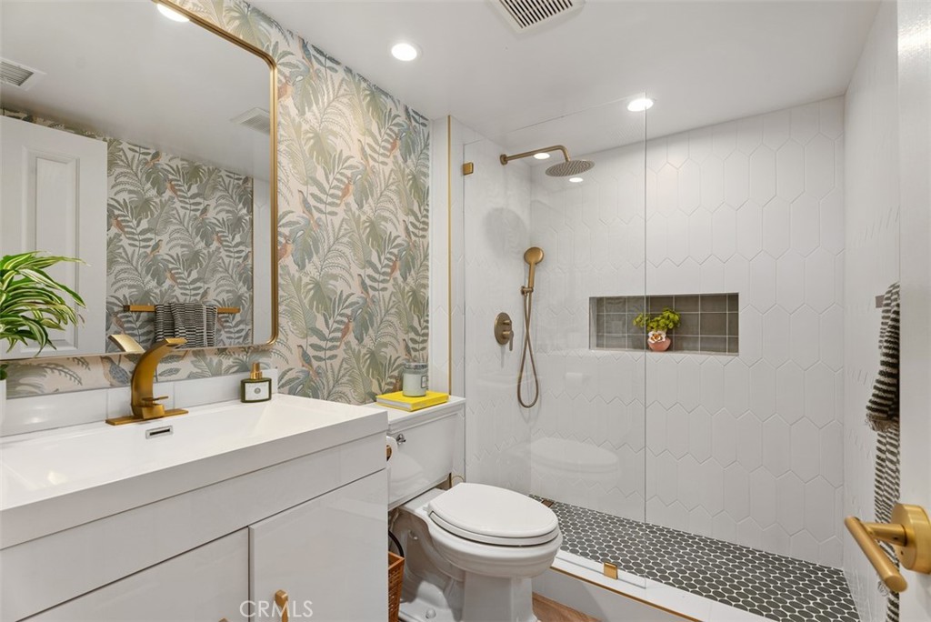 90 Cameray Heights Laguna Niguel, CA 92677 - Photo 18 of 36 a bathroom with a sink toilet a mirror and shower