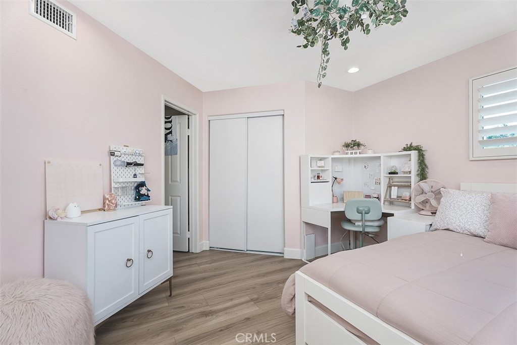 90 Cameray Heights Laguna Niguel, CA 92677 - Photo 19 of 36 a room with a bed and a chandelier