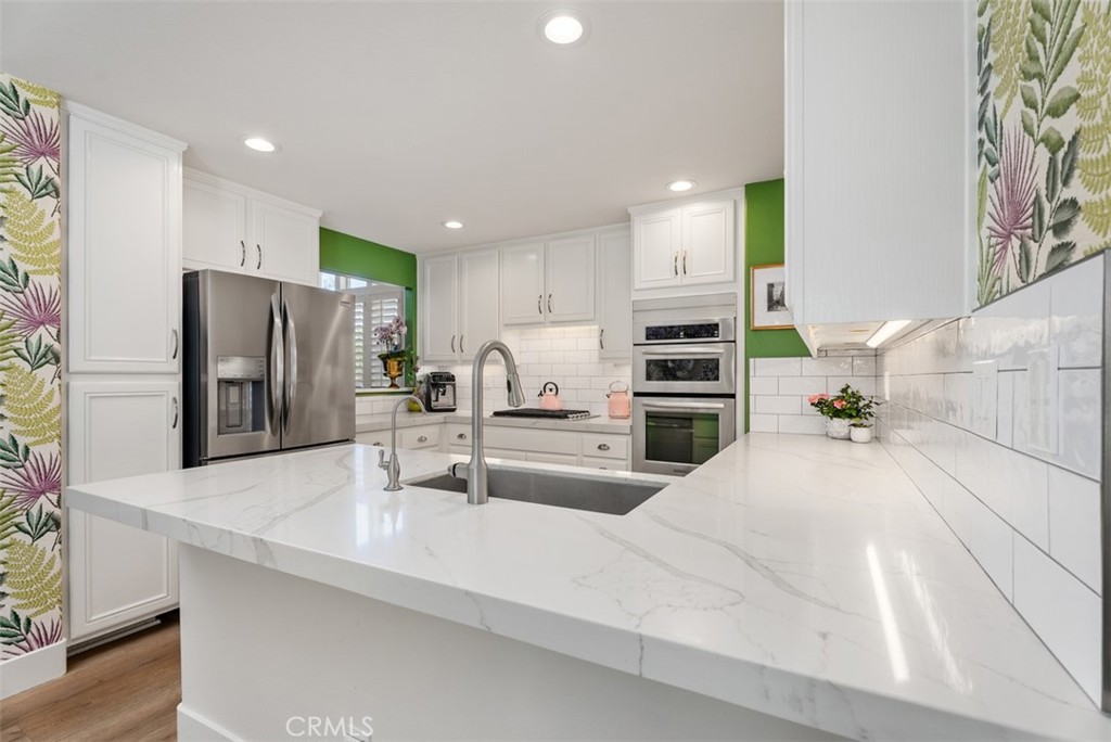 90 Cameray Heights Laguna Niguel, CA 92677 - Photo 8 of 36 a kitchen with stainless steel appliances kitchen island granite countertop a refrigerator and a sink
