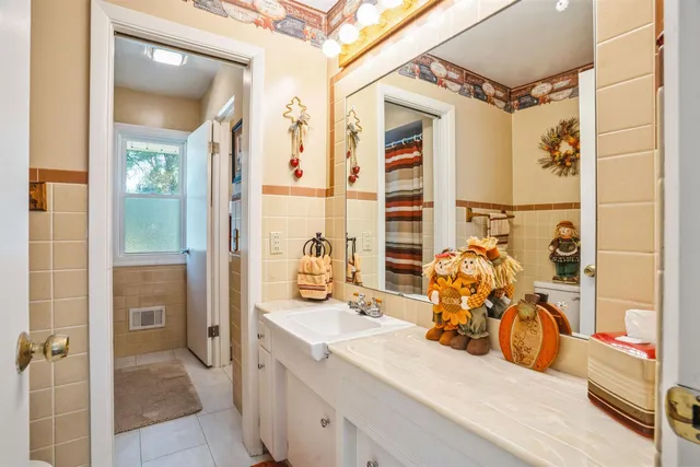 a bathroom with a double vanity sink mirror and shower