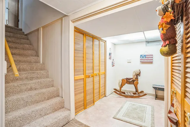 a view of a livingroom with wooden floor and furniture