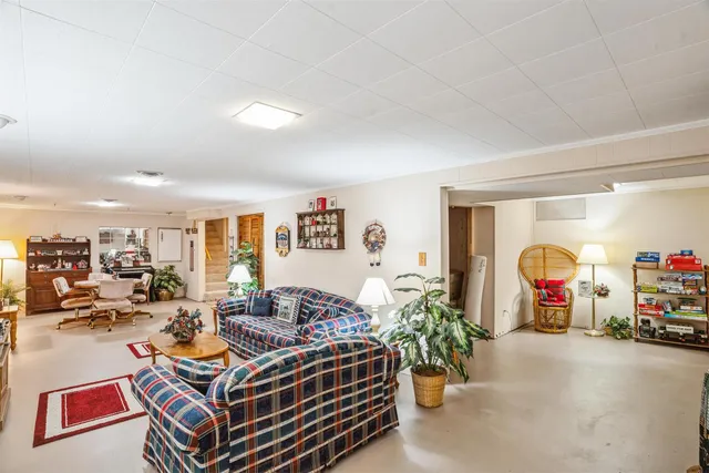 a living room with lots of furniture and a chandelier