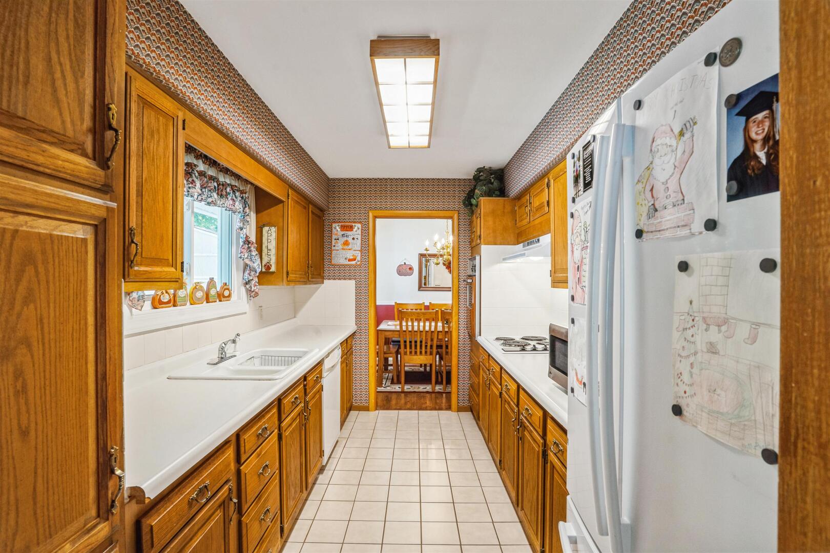 3431 37th Avenue Rock Island, IL 61201 - Photo 7 of 25 a large white kitchen with a large window