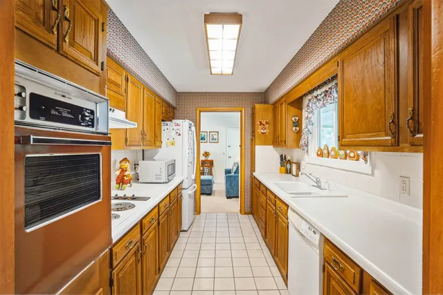 a large white kitchen with a large window