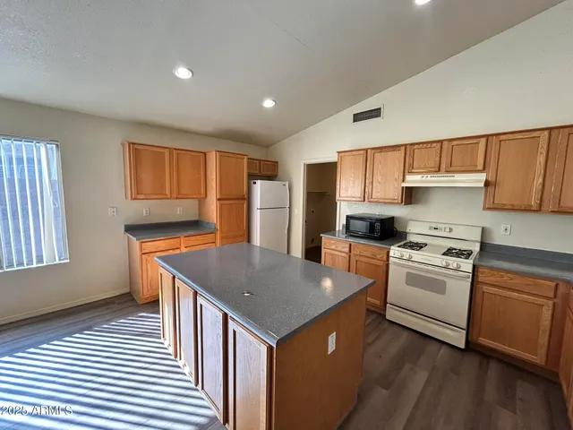a kitchen with a stove a sink and a refrigerator