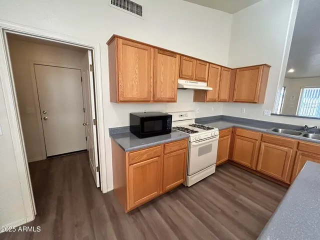 a kitchen with white cabinets and white appliances