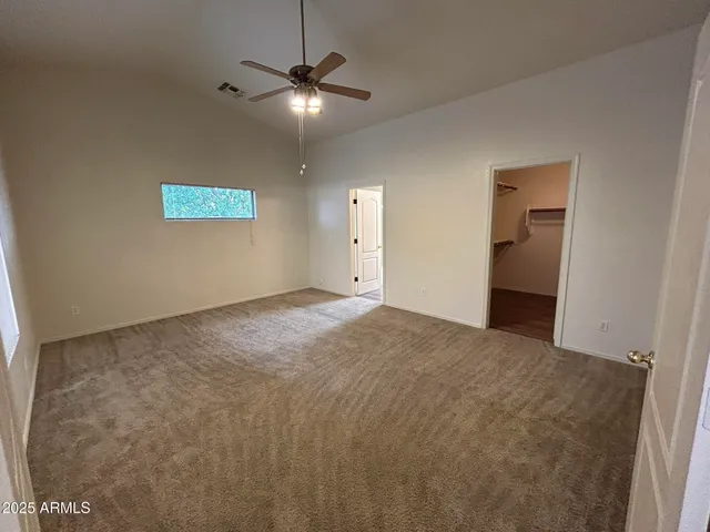 a view of a livingroom with a ceiling fan and window