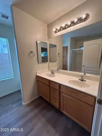 a bathroom with a double vanity sink a and mirror