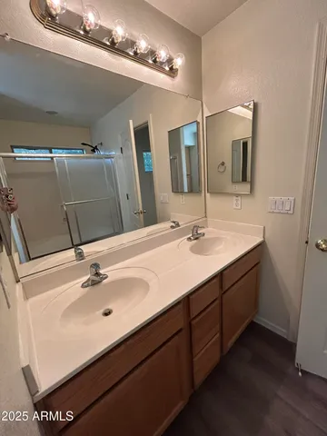 a bathroom with a double vanity sink and mirror