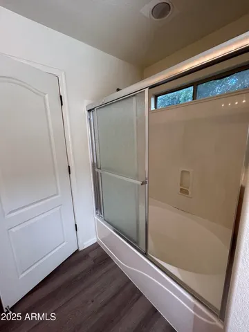a bathroom with a glass door shower