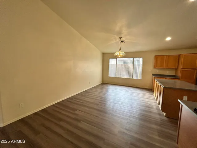 a view of a room with wooden floor and a window