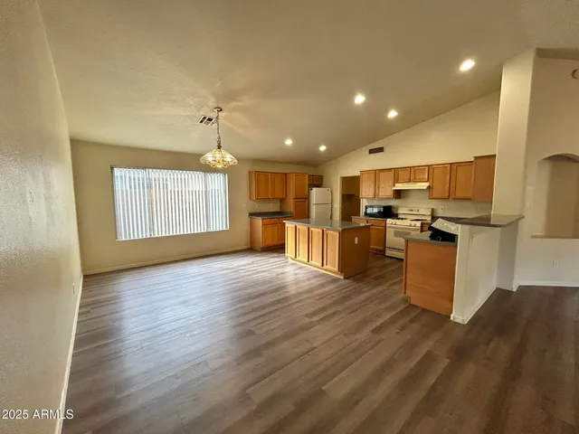 a view of kitchen with furniture and wooden floor